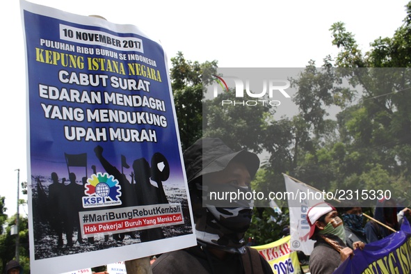 Thousands of workers surrounded the Jakarta Governor's office during a demonstration against the 2018 Regional Minimum Wage (UMP) award at J...