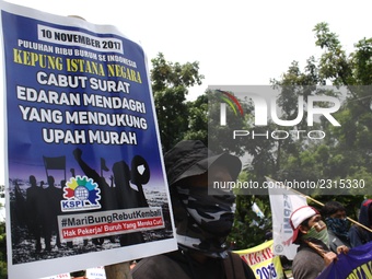 Thousands of workers surrounded the Jakarta Governor's office during a demonstration against the 2018 Regional Minimum Wage (UMP) award at J...