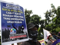 Thousands of workers surrounded the Jakarta Governor's office during a demonstration against the 2018 Regional Minimum Wage (UMP) award at J...