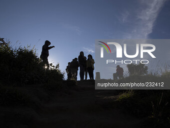 Visitors enjoying Mount Sindoro View from Sikunir Mountain at Dieng during the sunrise. Dieng plateau in Central Java, is part of the distri...