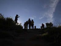 Visitors enjoying Mount Sindoro View from Sikunir Mountain at Dieng during the sunrise. Dieng plateau in Central Java, is part of the distri...