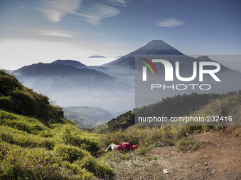 A visitor fell a sleep in front of Mount Sindoro View from Sikunir Mountain, some visitors choose to stay a night before to see the sunrise...