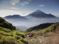 A visitor fell a sleep in front of Mount Sindoro View from Sikunir Mountain, some visitors choose to stay a night before to see the sunrise...