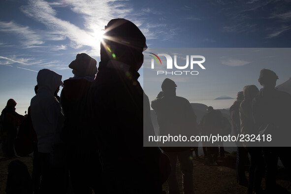 People enjoying sunrise from Top of Sikunir Mountain at Dieng. Dieng plateau in Central Java, is part of the district of Banjarnegara and Wo...