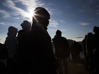 People enjoying sunrise from Top of Sikunir Mountain at Dieng. Dieng plateau in Central Java, is part of the district of Banjarnegara and Wo...