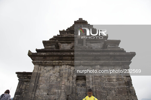 a child pose for photograph at Temple complex in Dieng. Dieng plateau in Central Java, is part of the district of Banjarnegara and Wonosobo...