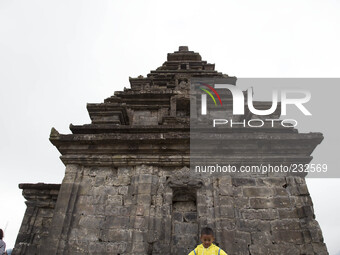 a child pose for photograph at Temple complex in Dieng. Dieng plateau in Central Java, is part of the district of Banjarnegara and Wonosobo...