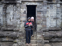 Couples inspect their digital camera after pose at a Temple in Complex Temple at Dieng. Dieng plateau in Central Java, is part of the distri...