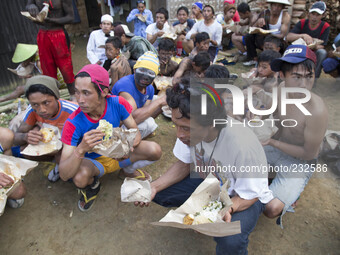 Participants of the villagers karnaval at Dieng eating together. Dieng plateau in Central Java, is part of the district of Banjarnegara and...