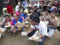 Participants of the villagers karnaval at Dieng eating together. Dieng plateau in Central Java, is part of the district of Banjarnegara and...