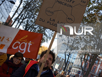 A man holds a placard reading 'The law of the wealthiest'. More than 4000 protesters took to the streets of Toulouse against the new Macron'...