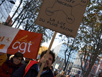 A man holds a placard reading 'The law of the wealthiest'. More than 4000 protesters took to the streets of Toulouse against the new Macron'...