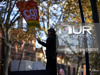 A man holds a flag of the CGT trade union. More than 4000 protesters took to the streets of Toulouse against the new Macron's reforms on the...