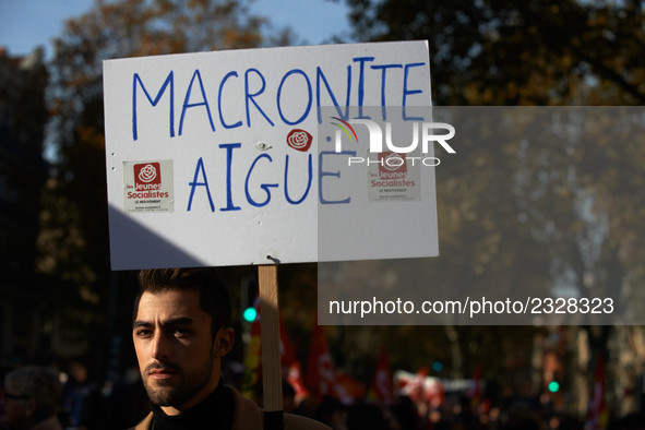 A man holds a placard reading "Acute Macronite'. More than 4000 protesters took to the streets of Toulouse against the new Macron's reforms...