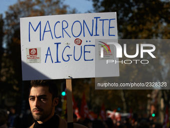 A man holds a placard reading "Acute Macronite'. More than 4000 protesters took to the streets of Toulouse against the new Macron's reforms...