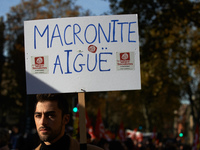 A man holds a placard reading "Acute Macronite'. More than 4000 protesters took to the streets of Toulouse against the new Macron's reforms...