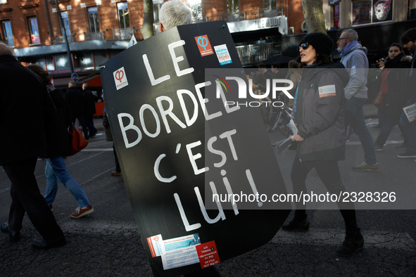 A man walks with a placard reading 'The mess, it's him !' in a reference to French President Macron. More than 4000 protesters took to the s...