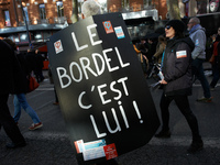 A man walks with a placard reading 'The mess, it's him !' in a reference to French President Macron. More than 4000 protesters took to the s...