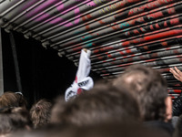 Protesters from the communist labour union PAME try to bring down the entrance of the Labour Ministry during a demonstration against changes...