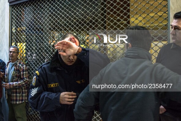 An injured riot police officer after the communist labour union PAME storming the Labour Ministry during a demonstration against changes to...