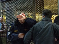 An injured riot police officer after the communist labour union PAME storming the Labour Ministry during a demonstration against changes to...