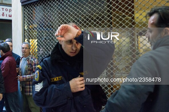 An injured riot police officer after the communist labour union PAME storming the Labour Ministry during a demonstration against changes to...