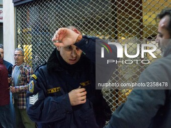 An injured riot police officer after the communist labour union PAME storming the Labour Ministry during a demonstration against changes to...