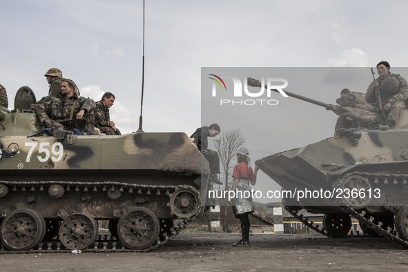 Ukrainian troops are intercepted by civilians who are trying to hinder the advance of their 