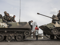 Ukrainian troops are intercepted by civilians who are trying to hinder the advance of their (