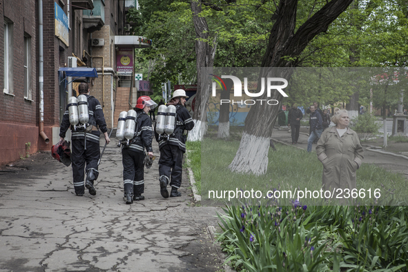 Some people and firemen observe the place where the Ukrainian army has launched a military offensive 