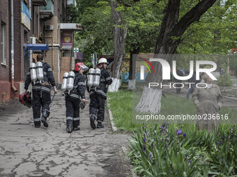 Some people and firemen observe the place where the Ukrainian army has launched a military offensive (