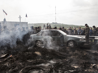 Pro-Russian civilians protesting against the advance of the Ukrainian army, after violent clashes the previous night. In the background Kara...