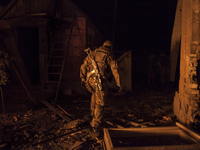 Pro-Russian paramilitary walks through the rubble of a bombed site (