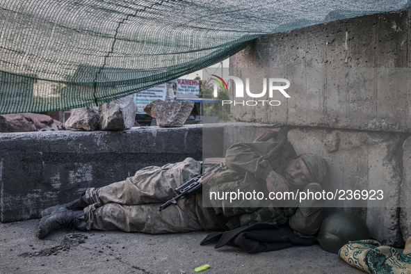 Pro-Russian militant sleeping after a night of intense fighting 