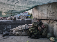 Pro-Russian militant sleeping after a night of intense fighting (