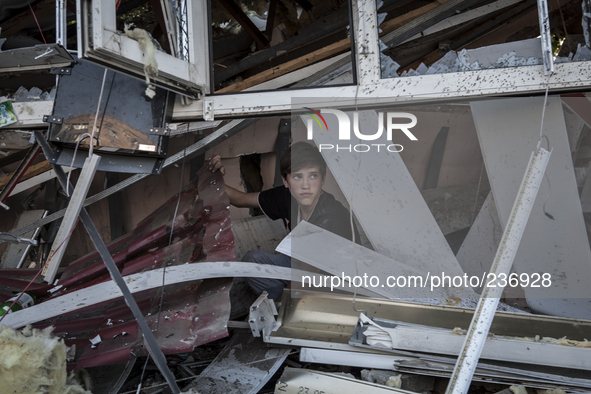 A child in the rubble of a destroyed building 