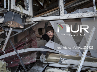 A child in the rubble of a destroyed building (