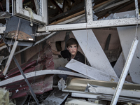 A child in the rubble of a destroyed building (