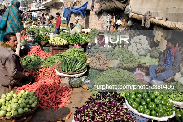 Indian fruit vendors while waiting for customers along a street at Vegetable Market at Sadar Bazar Gurugram in north Indian state of Haryana...