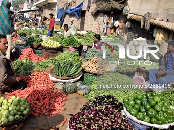 Indian fruit vendors while waiting for customers along a street at Vegetable Market at Sadar Bazar Gurugram in north Indian state of Haryana...