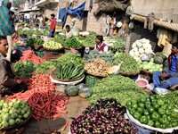 Indian fruit vendors while waiting for customers along a street at Vegetable Market at Sadar Bazar Gurugram in north Indian state of Haryana...