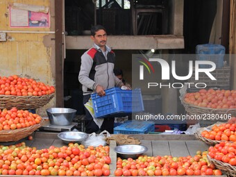 An Indian fruit vendor loads apples at Vegetable Market at Sadar Bazar Gurugram in north Indian state of Haryana on 16 December 2017.  (