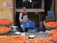 An Indian fruit vendor loads apples at Vegetable Market at Sadar Bazar Gurugram in north Indian state of Haryana on 16 December 2017.  (