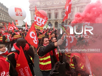 French General Confederation of Labour (CGT) unionists hold smoke canisters as they gather in front of Paris' Opera Garnier on December 20,...