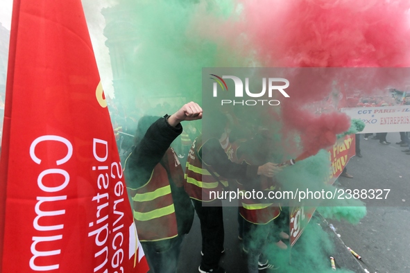 French General Confederation of Labour (CGT) unionists hold smoke canisters as they gather in front of Paris' Opera Garnier on December 20,...