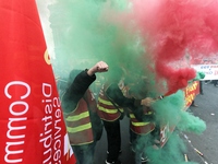 French General Confederation of Labour (CGT) unionists hold smoke canisters as they gather in front of Paris' Opera Garnier on December 20,...