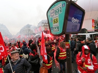 French General Confederation of Labour (CGT) unionists gather in front of Paris' Opera Garnier on December 20, 2017, to protest against Fren...