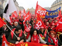 French General Confederation of Labour (CGT) unionists gather in front of Paris' Opera Garnier on December 20, 2017, to protest against Fren...