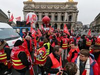 French General Confederation of Labour (CGT) unionists gather in front of Paris' Opera Garnier on December 20, 2017, to protest against Fren...