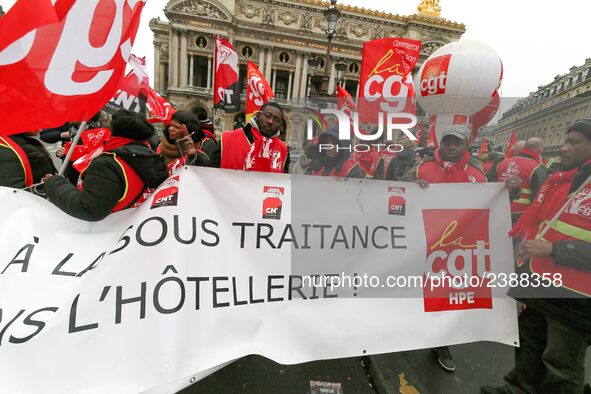 French General Confederation of Labour (CGT) unionists hold a banner reading "no to subcontracting in hotel industry" as they gather in fron...